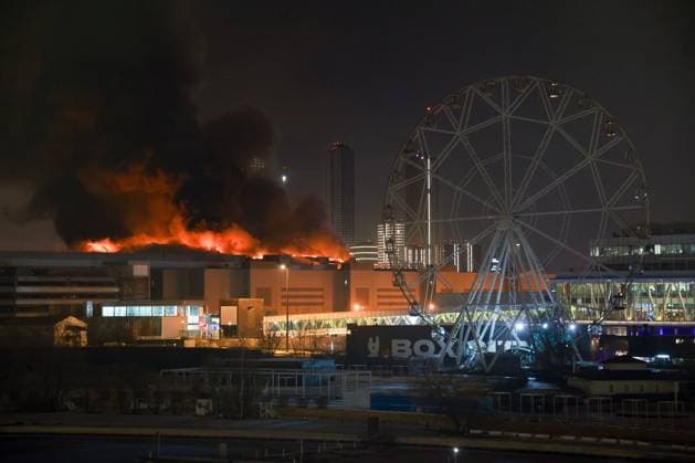 RUSSIA, MOSCOW REGION - MARCH 22, 2024: Smoke rises over the Crocus City Hall in the town of Krasnogorsk where unidentified persons opened fire. Evacuation is underway. Vyacheslav Prokofyev TASS  68457178