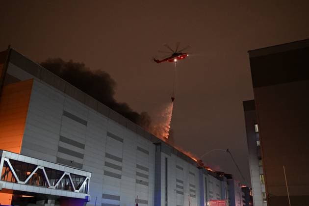 Russia Terrorist Attack 8647858 22.03.2024 Firefighters operate a helicopter as they work to extinguish a fire at the burning Crocus City Hall concert venue following a shooting incident, outside Moscow, Russia. The Russian Federal Security Service (FSB) said that there are people dead and injured as a result of the terrorist attack in the concert hall in Moscow region. A massive fire has also broken out at the venue. Alexey Maishev Sputnik Moscow region Russia  Copyright: xAlexeyxMaishevx