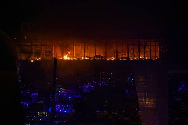 (240322) -- MOSCOW, March 22, 2024 -- Smoke from fire rises above the burning Crocus City Hall concert venue following a shooting incident in the northwest of Moscow, Russia, on March 22, 2024. At least 40 people were killed and more than 100 injured after a shooting at the Crocus City Hall concert venue on Friday, according to preliminary data from the Russian Federal Security Service. ) RUSSIA-MOSCOW-CONCERT VENUE-SHOOTING CaoxYang 