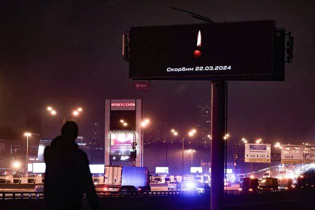 RUSSIA, MOSCOW REGION - MARCH 23, 2024: A person walks by a billboard poster reading We Mourn 22.03.2024 after a terrorist attack at the Crocus City Hall in the town of Krasnogorsk, where several unidentified gunmen opened fire on people before the start of a performance. Mikhail Tereshchenko TASS  68462456