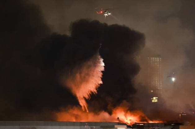RUSSIA, MOSCOW REGION - MARCH 22, 2024: A helicopter battles a fire at the Crocus City Hall in the town of Krasnogorsk after a terrorist attack, where several unidentified gunmen opened fire on people before the start of a concert. Vyacheslav Prokofyev TASS  68463257
