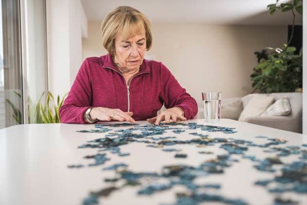 Senior woman playing puzzle at home model released, Symbolfoto property released, UUF31156