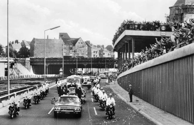 J.F.K. IN BERLIN, 1963. The American President John F. Kennedy during his drive through Berlin in an open car on 26 June 1963. With Kennedy is Willy Brandt, governing mayor of Berlin, and German Chancellor Konrad Adenauer.  Copyright: xGRANGERx xGRANGERx 0090350