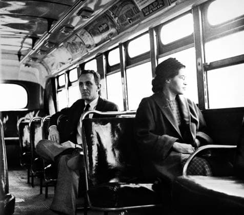 ROSA PARKS (1913-2005). American civil rights advocate. Sitting at the front of a public bus (formerly whites only ) in Montgomery, Alabama, on the day buses were integrated in the city. Seated behind her is reporter Nicholas C. Criss. Photograph, 21 December 1956.  Copyright: xGRANGERx xGRANGERx 0107383