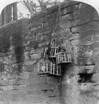 CHINA: BOXER REBELLION. Five wooden crates containing the heads of pirates hanging over the wall at Honam, China, displayed by Li Hung Chang as a reminder to the lawless. Stereograph, c1900.  Copyright: xGRANGERx xGRANGERx 0118189