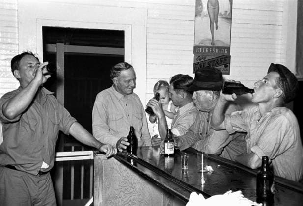 LOUISIANA: TAVERN, 1938. Men drinking beer at the bar in Pilottown, Louisiana. Photograph by Russell Lee, September 1938.  Copyright: xGRANGERx xGRANGERx 0121494