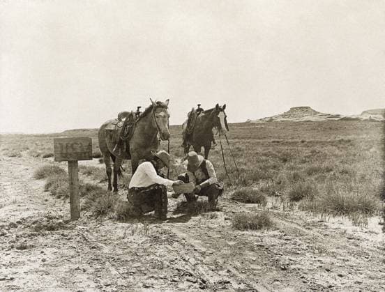 TEXAS: COWBOYS, c1907. Two cowboys reading mail next to a USM postbox near the LS Ranch in Texas. Photograph by Erwin Evans Smith, c1907.  Copyright: xGRANGERx xGRANGERx 0124923