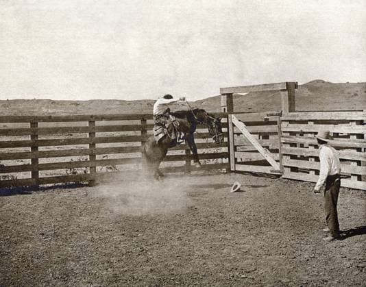TEXAS: COWBOYS, c1907. Two cowboys breaking a horse in a corral on the LS Ranch in Texas. Photograph by Erwin Evans Smith, c1907.  Copyright: xGRANGERx xGRANGERx 0124931