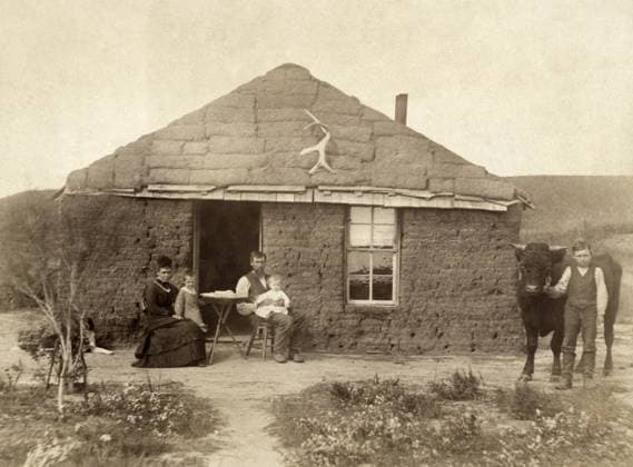 NEBRASKA: SETTLERS, c1886. Family of homesteaders, photographed outside of their sod house with a boy holding a bull by a rope, Custer County, Nebraska. Photograph by Solomon D. Butcher, c1886.  Copyright: xGRANGERx xGRANGERx 0130680