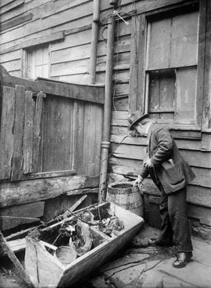 NEW YORK: TENEMENT, c1910. A public health inspector identifying mosquito breeding areas in the backyards of tenement buildings in an effort to prevent the spread of mosquito-borne diseases. Photograph, c1910.  Copyright: xGRANGERx xGRANGERx 0323434