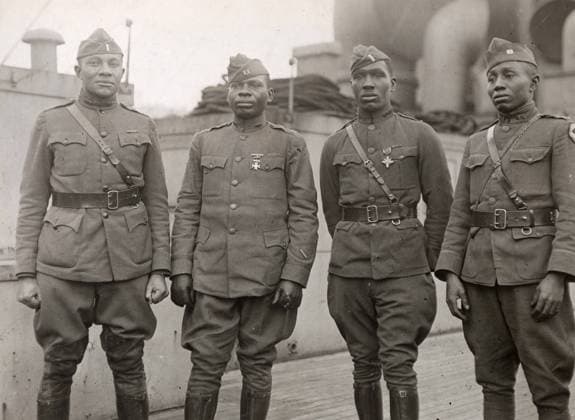 WWI: HOMECOMING, 1919. Lieutenant Cleveland L. Abbot, Captain Joseph Lowe, Lieutenant Aaron R. Fisher, and Captain E. White, officers of the 366th Infantry Regiment, returning home aboard the RMS Aquitania. Photograph, 1919.  Copyright: xGRANGERx xGRANGERx 0528287