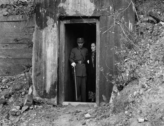 CHIANG KAI-SHEK (1887-1975). Chinese general and politician. With his wife, Soong May-Ling in the doorway of their shelter during the bombing of Chongqing, China, during the Second Sino-Japanese War, 1938-1943.  Copyright: xGRANGERx xGRANGERx 0640082