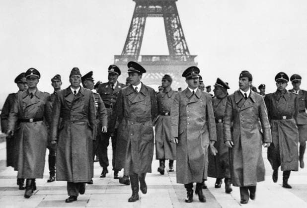 ADOLF HITLER (1889-1945). Chancellor of Germany, 1933-1945. Hitler in front of the Eiffel Tower in Paris. Next to him from left: SS leader Karl Wolff; architects Hermann Giesler and Albert Speer. Background: Colonel General Wilhelm Keitel, chief of the OKW; the personal adjutant SA Lieutenant General Wilhelm Brückner. Photograph, 23 June 1940.  Copyright: xGRANGERx xGRANGERx 0640598