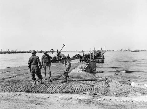 WWII: NORMANDY, 1944. U.S. soldiers constructing a landing ramp as part of the Mulberry A artificial harbor at Omaha Beach, Normandy, France. Photograph, June 1944.  Copyright: xGRANGERx xGRANGERx 0644758