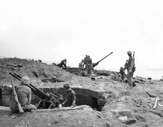 WWII: IWO JIMA, 1945. American Marines inspecting captured Japanese anti-aircraft emplacements during the Battle of Iwo Jima. Photograph from the United States Marine Corps, 1945.  Copyright: xGRANGERx xGRANGERx 0644949