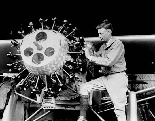 CHARLES A. LINDBERGH (1902-1974). American aviator. Lindbergh examining the cylinders of the Spirit of St. Louis. Photograph, 1927.  Copyright: xGRANGERx xGRANGERx 0651211