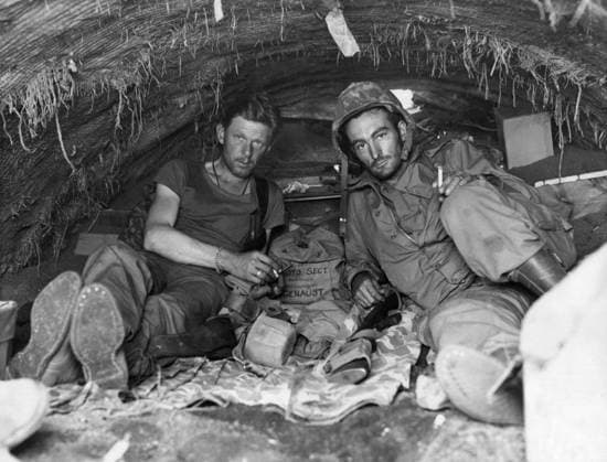 WWII: IWO JIMA, 1945. United States marines Sergeant W. A. Genaust and Corporal Atlee S. Tracy sheltering in captured Japanese dugout during the Battle of Iwo Jima. Photograph by Karl Thayer Soule, 1945.  Copyright: xGRANGERx xGRANGERx 0651640