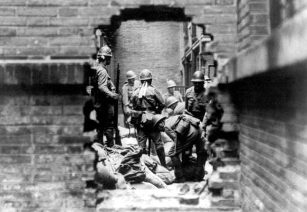 China: Imperial Japanese soldiers involved in street fighting during the Battle of Shanghai (August 13 - Nov 26, 1937) pause to examine a dead Chinese soldier. The Second Sino-Japanese War (July 7, 1937 September 9, 1945) was a military conflict fought primarily between the Republic of China and the Empire of Japan. After the Japanese attack on Pearl Harbor, the war merged into the greater conflict of World War II as a major front of what is broadly known as the Pacific War.<br ><br > Although the two countries had fought intermittently since 1931, total war started in earnest in 1937 and ended only with the surrender of Japan in 1945. The war was the result of a decades-long Japanese imperialist policy aiming to dominate China politic Copyright: xxPicturesxFromxHistoryx