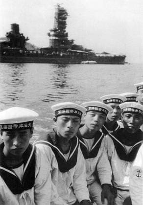 Japan: Crew members of the Japanese battleship Fuso moored in the background, Kure, Hiroshima, May 1943 Fuso (a classical name for Japan) was the lead ship of the two Fuso-class dreadnought battleships built for the Imperial Japanese Navy. Launched in 1914 and commissioned in 1915, she initially patrolled off the coast of China, playing no part in World War I. In 1923, she assisted survivors of the Great Kanto Earthquake.<br ><br > Fuso was modernized in 1930 35 and again in 1937 41, with improvements to her armor and machinery and a rebuilt superstructure in the pagoda mast style. With only 14-inch guns, she was outclassed by other Japanese battleships at the beginning of World War II, and played auxiliary roles for most of the war.<b Copyright: xxPicturesxFromxHistoryx