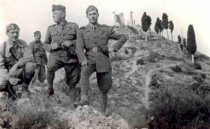 Portrait of a group of four soldiers in uniform photographed on a rocky promontory observing the surroundings. One of them has a spyglass. Behind them are a few cypresses and ruins at the top of a hill, 05 1938 (b w photo) 1250005 Portrait of a group of four soldiers in uniform photographed on a rocky promontory observing the surroundings. One of them has a spyglass. Behind them are a few cypresses and ruins at the top of a hill, 05 1938 (b w photo) by Unknown photographer, (20th century); (add.info.: Unidentified Author); Fratelli Alinari Museum Collections, Florence, Italy. Copyright: xFratellixAlinarixMuseumxCollections,xFlorence,xItalyx xBridgemanxImagesx 1250005