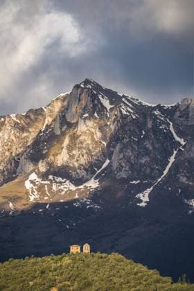 MR_ID20228_16662_JuanLopez.jpg A lone church nestled on a forested hilltop before the majestic, snow-dusted peaks of Picos de Europa National Park. Model Released JuanLopez_ID20228_598504_010 Copyright: xJuanxLopezx