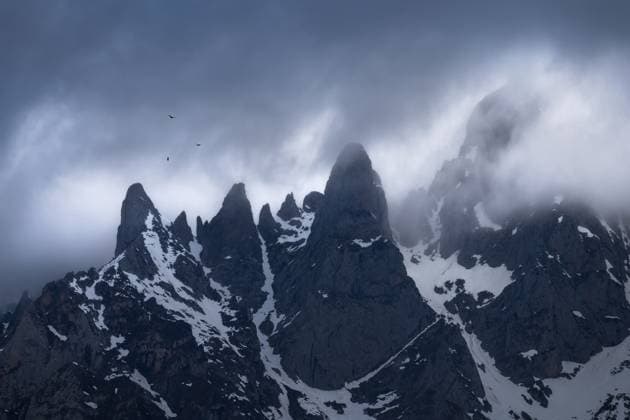 MR_ID20228_16662_JuanLopez.jpg Dramatic view of the mist-covered mountain peaks in Picos De Europa National Park with snow patches clinging to rocky terrain. Model Released JuanLopez_ID20228_598506_012 Copyright: xJuanxLopezx