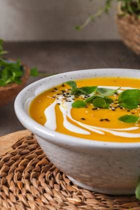 Creamy pumpkin soup Delicious homemade creamy pumpkin soup with cream with sesame seeds and watercress. Copyright: xZoonar.com homydesignx 21148770