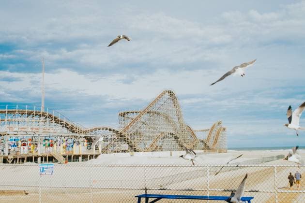 Seagulls fly through view of wooden rollercoaster on the beach Wildwood, New Jersey, United States R_TLGH240408-1385802-01 EDITORIAL USE ONLY