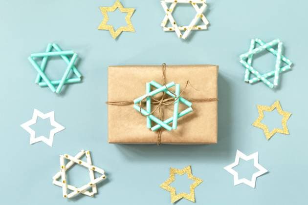 Jewish holiday Hanukkah. A gift and symbol of Hanukkah star of David on a blue background. Top view flat lay. Jewish holiday Hanukkah. A gift and symbol of Hanukkah star of David on a blue background. Top view flat lay. Copyright: xZoonar.com ELENAxHRAMOVAx 21188958