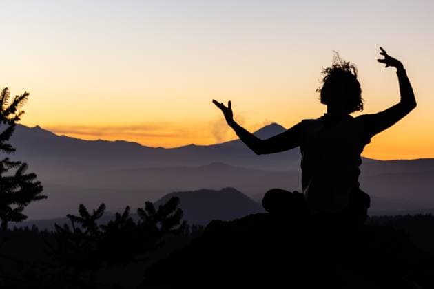 A dancer s silhouette is captured against the vibrant hues of a mountain sunset, reflecting a tranquil yet invigorating scene Model Released EduardoGavira_ID20613_608865_006 Copyright: xEduardoxGavirax
