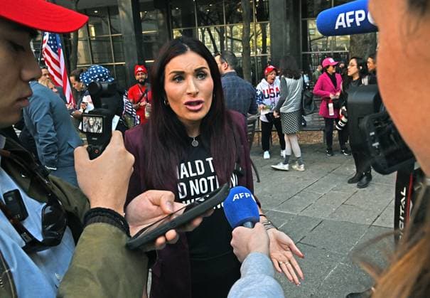 Donald Trump supporter and political activist Laura Loomer speaks outside Manhattan criminal court as the former president arrives for the first day of his criminal trial in New York, on Monday, April 15, 2024. Trump, the first former president to stand trial on criminal charges, is charged with 34 counts of falsifying business records to allegedly cover hush money payments to adult-film star Stormy Daniels in 2016.  NYP20240415602 LouisxLanzano