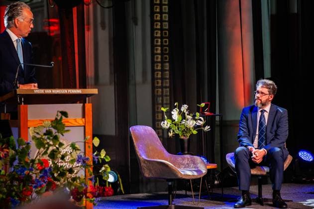Treaties of Nijmegen Medal 2024 awarded to Bellingcat founder Eliot Higgins in Nijmegen - 18 Apr 2024 Secretary-General of the Ministry of Foreign Affairs, Paul Huijts (L) is seen giving a speech in front of Eliot Higgins (R) from Bellingcat. The Treaties of Nijmegen Medal is a biannual prize awarded to a key international figure or an organization that has made a special contribution in politics, science, economics, or culture to the development and position of Europe, or has contributed to the European peace. This year, Eliot Higgins, the British founder of the international investigative journalism collective Bellingcat received the award for his innovative contribution to peace and human rights. Nijmegen Netherlands Copyright: xAnaxFernandezx xSOPAxImagesx Ana_Fernandez_180424_TreatiesNijmegenMedalEliotHiggins_011