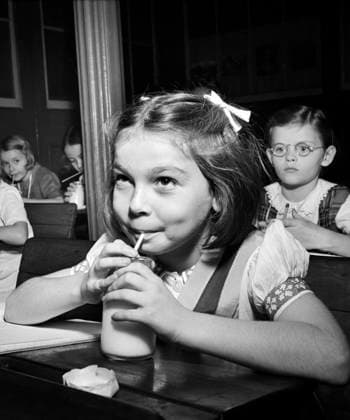 Young girl drinking glass of milk in classroom, New York City, New York, USA, Marjory Collins, U.S. Office of War Information, October 1942  Copyright: xCircaxImagesx ghi-circa12531