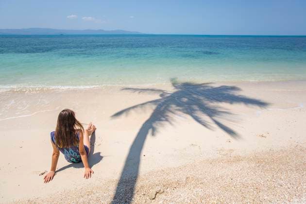 Woman resting on beach at sunny day model released, Symbolfoto, IKF01773