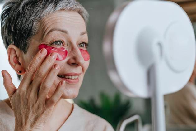 Creative Highlights Symbolbilder Mature woman applying eye mask at home model released, Symbolfoto property released, YTF02136