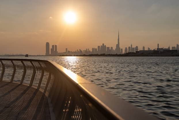 Downtown Dubai at Sunset A picture of Downtown Dubai at sunset, as seen from afar, with the Burj Khalifa towering all high rises. Copyright: xZoonar.com BrunoxCoelhox 21357651