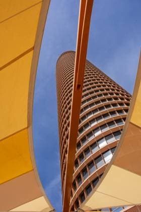 Creative Highlights World Skyward view of a modern skyscraper with orange geometric accents against blue sky, Torre Sevilla, Seville, Andalusia, Spain, Europe *** skyward View of a Modern Skyscraper With Orange GEOMETRIC accents against Blue sky, Torre Seville, Seville, Andalusia, Spain, Europe Copyright: imageBROKER/CarlosxSanchezxPerey ibxcsp10498620.jpg