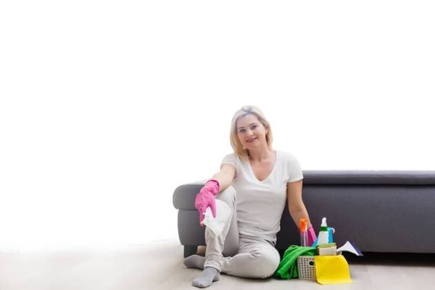 Young woman holding cleaning tools, isolated on white Young woman holding cleaning tools, isolated on white. Copyright: xAndriixSynenkyi RECORD DATE NOT STATED