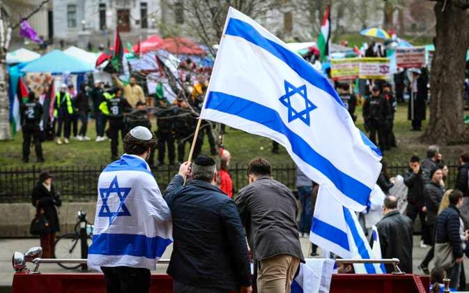 May 2, 2024, Montreal, Quebec, Canada: On Day 6 of McGill encampment, pro-Palestinian and pro-Israel protesters face off. Police in riot gear have lined up at campus entrance, keeping both groups separate. Montreal Canada - ZUMAs278 20240502_zip_s278_002 Copyright: xSerkanxSenturkx