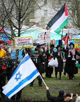 May 2, 2024, Montreal, Quebec, Canada: On Day 6 of McGill encampment, pro-Palestinian and pro-Israel protesters face off. Police in riot gear have lined up at campus entrance, keeping both groups separate. Montreal Canada - ZUMAs278 20240502_zip_s278_003 Copyright: xSerkanxSenturkx