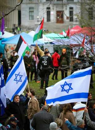 May 2, 2024, Montreal, Quebec, Canada: On Day 6 of McGill encampment, pro-Palestinian and pro-Israel protesters face off. Police in riot gear have lined up at campus entrance, keeping both groups separate. Montreal Canada - ZUMAs278 20240502_zip_s278_006 Copyright: xSerkanxSenturkx