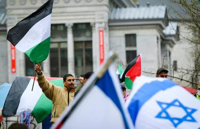 May 2, 2024, Montreal, Quebec, Canada: On Day 6 of McGill encampment, pro-Palestinian and pro-Israel protesters face off. Police in riot gear have lined up at campus entrance, keeping both groups separate. Montreal Canada - ZUMAs278 20240502_zip_s278_012 Copyright: xSerkanxSenturkx