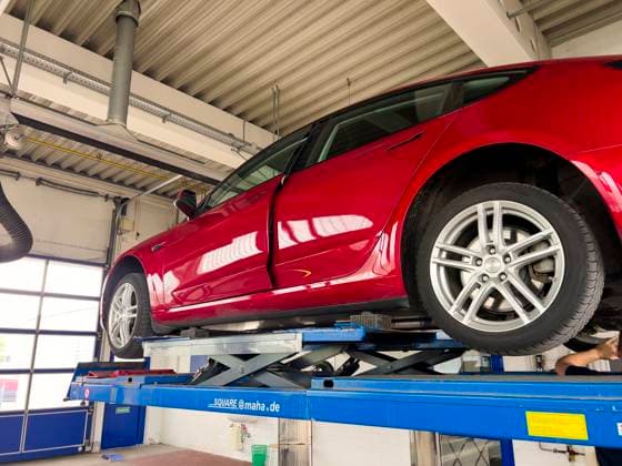 03 04 2024, A Tesla Model 3 in red color in the workshop Official vehicle inspection 03 05 2024, E car 03 05 2024, E car