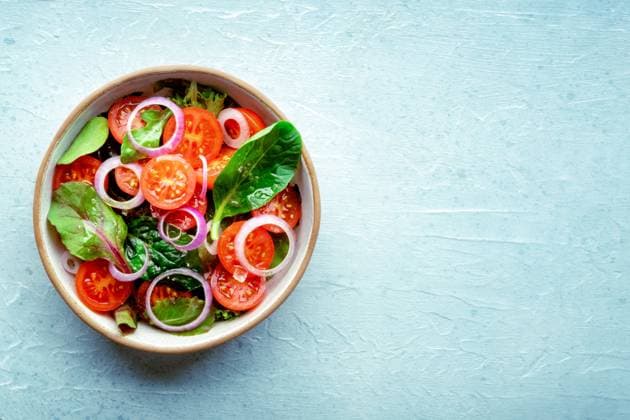 Salad with tomato, fresh leaves, and onions, overhead flat lay shot Salad with tomato, fresh leaves, and onions, overhead flat lay shot. Healthy diet, simple vegan recipe, with copy space Copyright: xZoonar.com KaterinaxSolovyevax 21589388