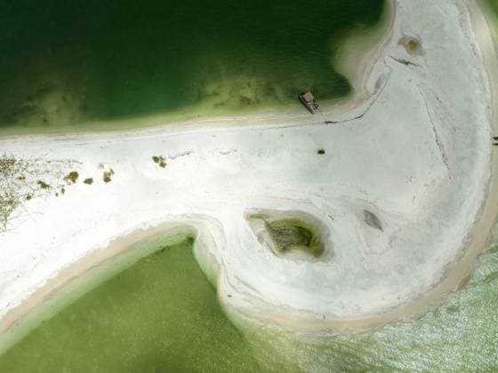 Aerial view of a sandbar among Marco Island Thousand Islands in the middle of the ocean with a boat docked Aerial view of a sandbar among Marco Island Thousand Islands in the middle of the ocean with a boat docked on the sand in Southwest Florida. Copyright: xZoonar.com Jayceex 21593988