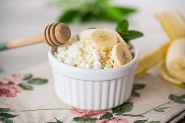 crumbly organic cottage cheese with honey and bananas in a ceramic bowl crumbly organic cottage cheese with honey and bananas in a ceramic bowl on the table Copyright: xPeredniankina RECORD DATE NOT STATED
