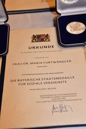 Certificate from Dr. Maria Furtwängler Award of the Bavarian State Medal for Social Merit 2024 Heilige Hofkirche Munich 07 May 2024