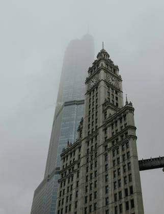 Creative Highlights World Foggy view of the Wrigley Building with a modern skyscraper in Chicago Chicago, Illinois, United States R_YVLB240507-1418123-01