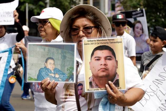 A mother of a missing person holds a a photo of her loved one as takes part during a protest on Mother s Day to demand that the government clarify the disappearances at Monument to the Mother course to the National Palace at Zocalo Square. Mexico City Mexico - ZUMAe321 20240510_zia_e321_005 Copyright: xLuisxBarronx