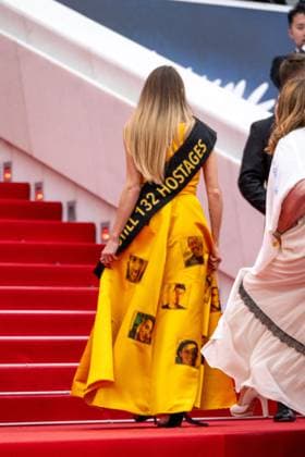 Cannes - Israeli Hostages Support at Screening of Mad Max Furiosa AAR A woman wearing a yellow dress calling for the release of Israeli hostages held by Hamas movement, seen on the stairs, prior the screening of Mad Max ?Furiosa?, as part of 77th edition of Cannes Film Festival, in Cannes, France, on May 15, 2024. Photo by Ammar Abd Rabbo ABACAPRESS.COM Cannes France  Copyright: xAbdxRabboxAmmar ABACAx